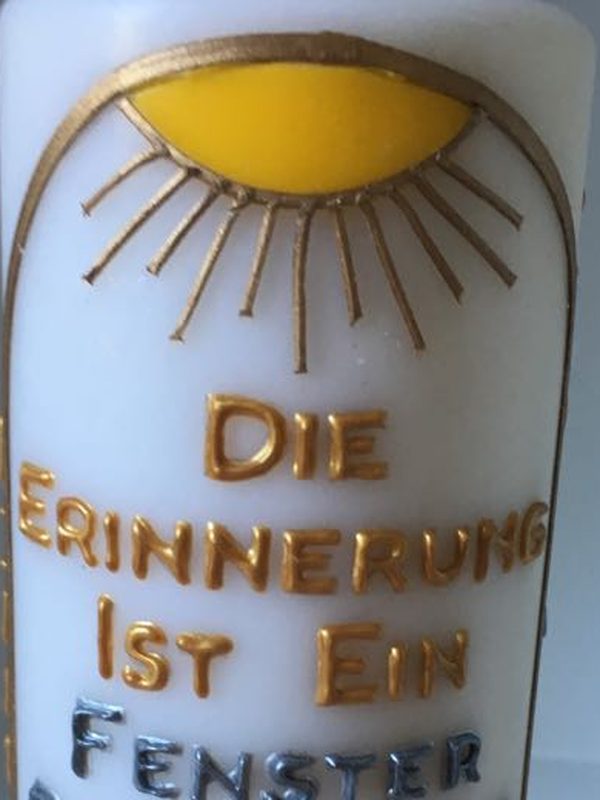 Close-up of a golden sun on a candle