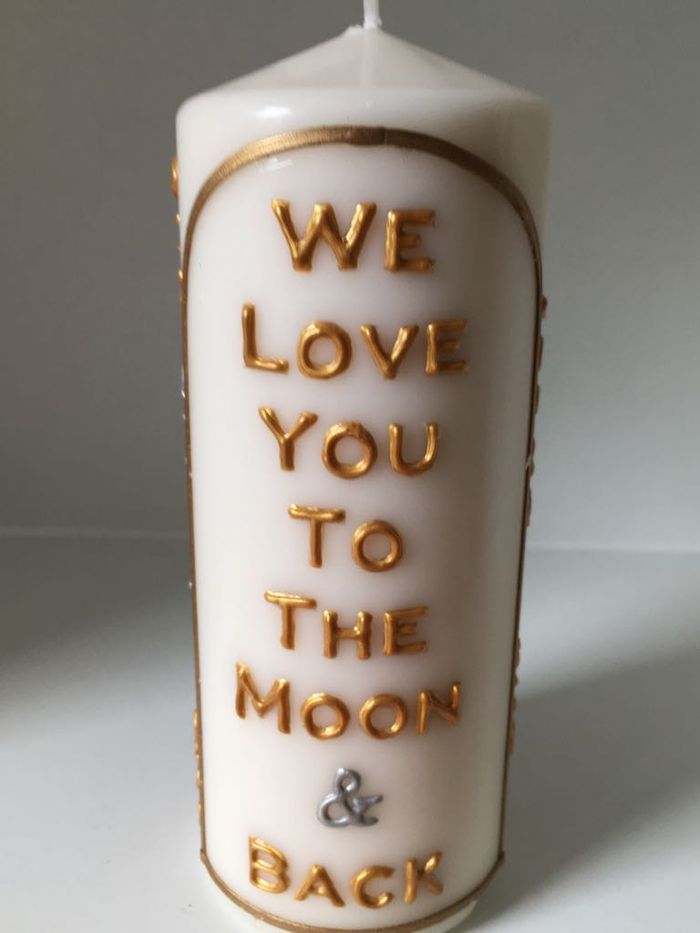 Candle lettered in gold: We love you to the moon and back