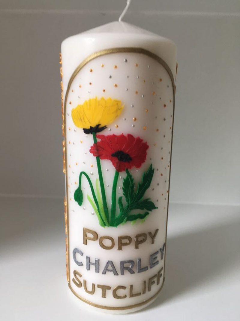 Candle for Poppy Charley Sutcliff decorated with red and yellow poppies